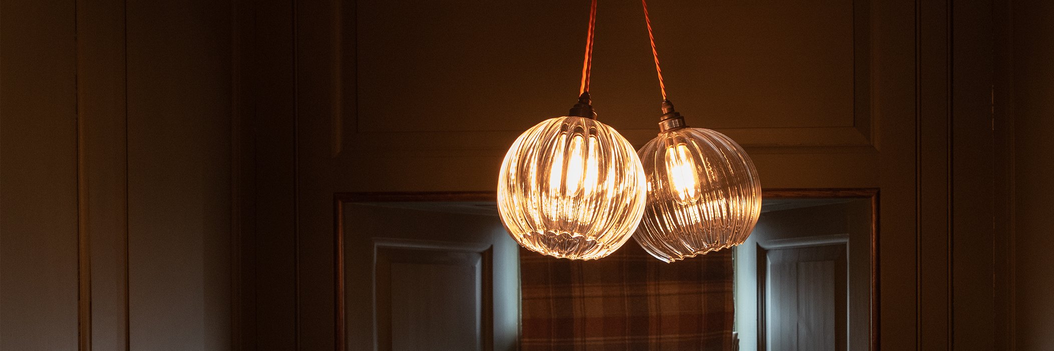Two clear ribbed Hereford pendant lights from hotel ceiling light collection, ideal for both commercial settings.