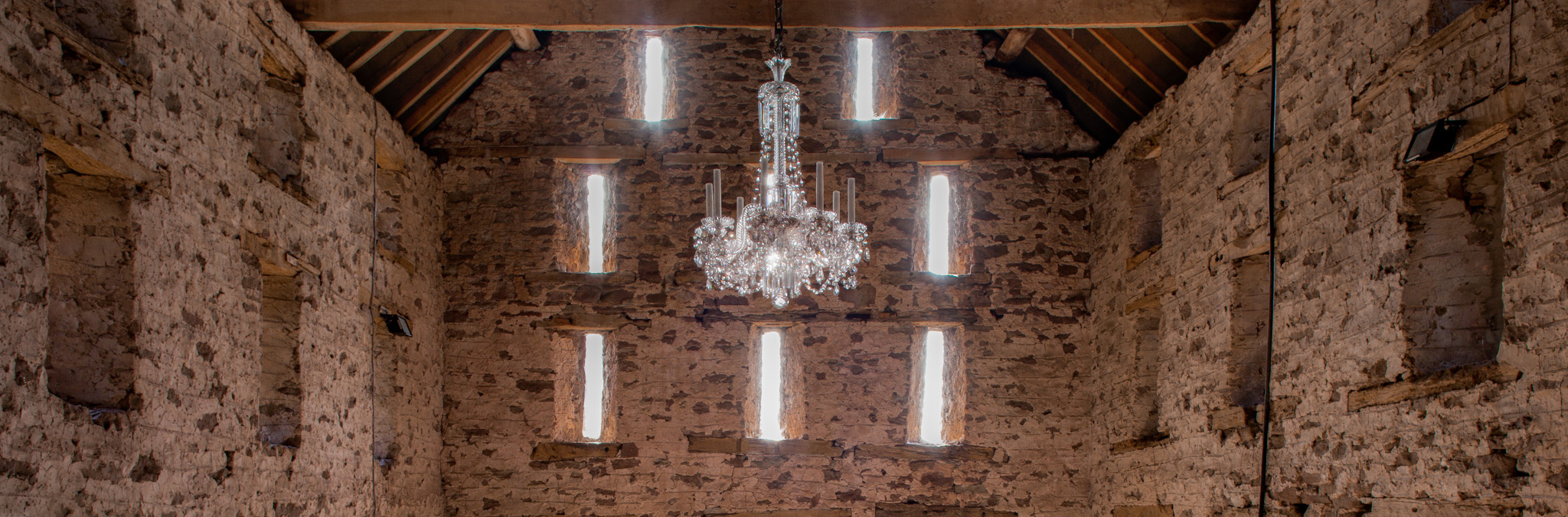 Fritz fryer antique crystal chandelier suspended in a barn in Herefordshire