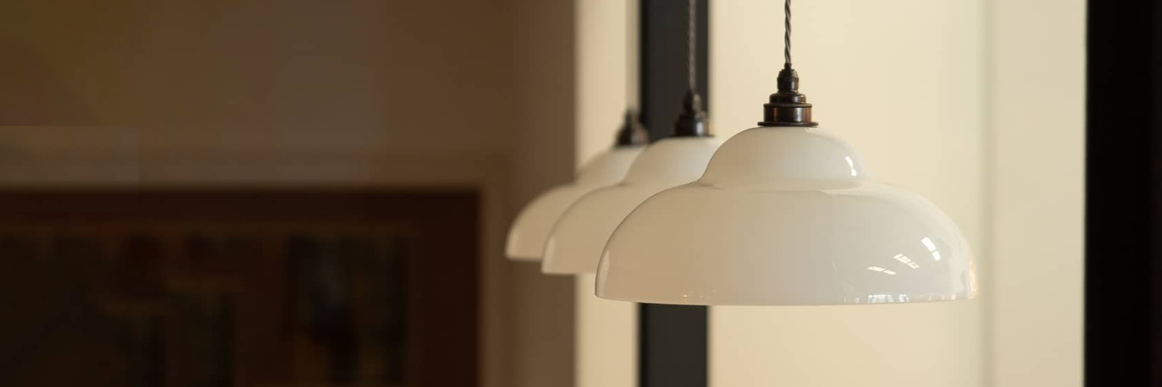 3-White-Glass-Pendant-Lights-In-a-row-over-kitchen-island