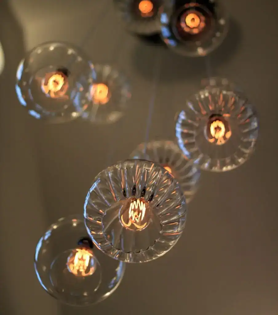 Modern glass pendant light fixtures with exposed filament bulbs.