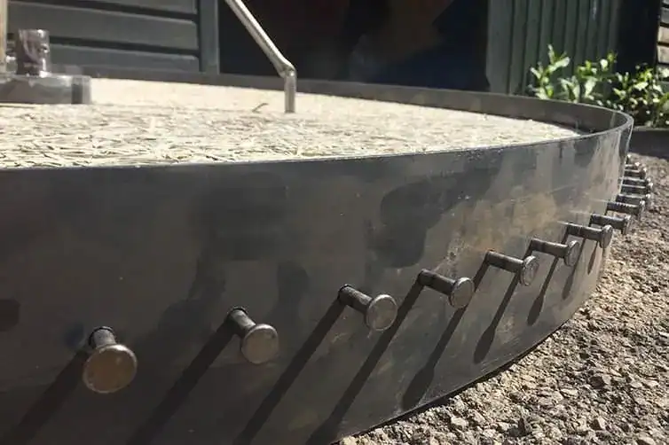 Outdoor fire pit with metal rim and embedded stones.
