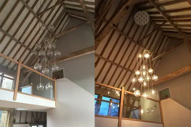 Modern chandelier with multiple glass globes hanging from a wooden ceiling.