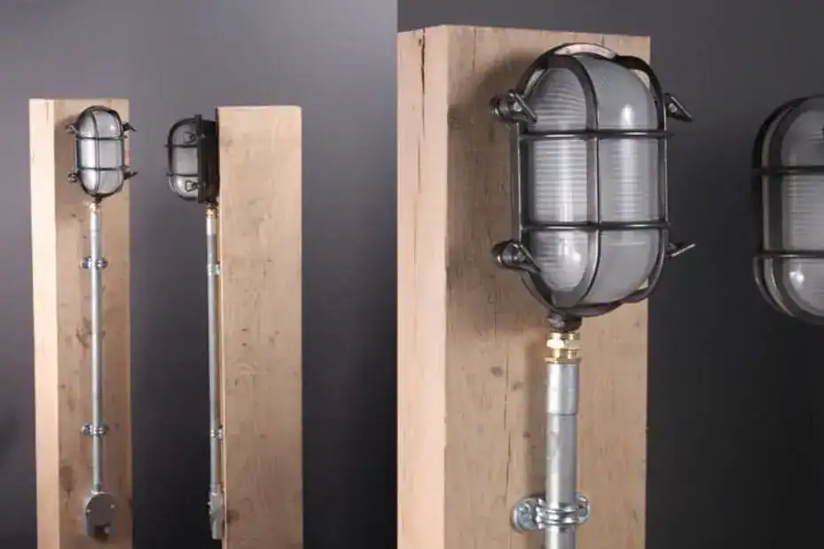 Industrial wall-mounted lighting fixtures on wooden panels.