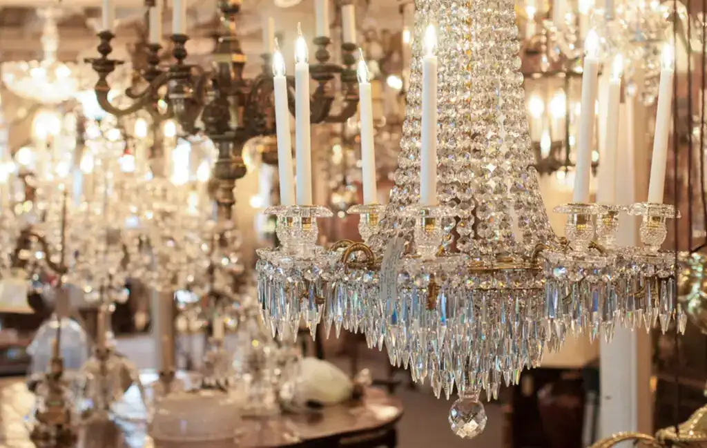 Elegant crystal chandelier with lit candles, showcasing luxurious lighting fixtures at Fritz Fryer L.