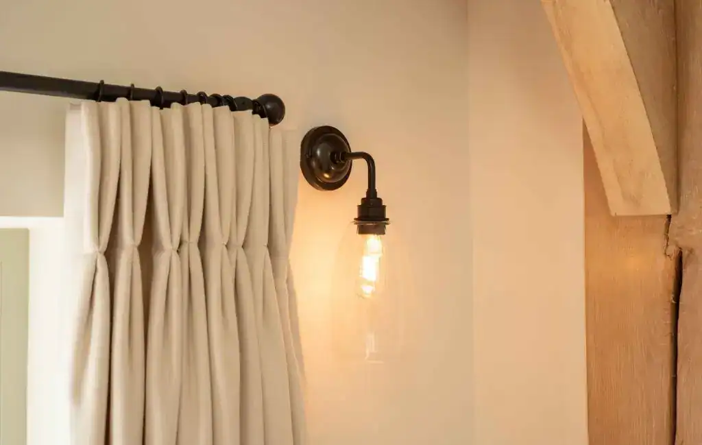 Vintage wall sconce with exposed filament bulb.