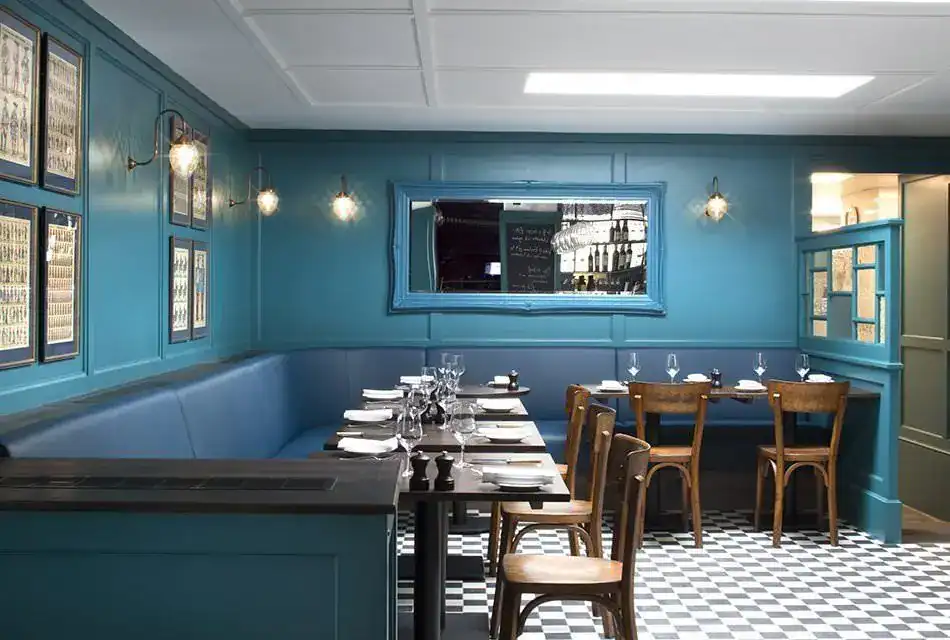 Elegant blue restaurant interior with modern lighting fixtures.