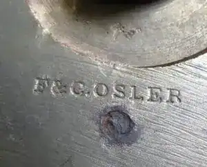 Fritz Fryer lighting component with engraved text.