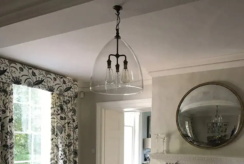 Pendant light with glass shade in a modern interior.