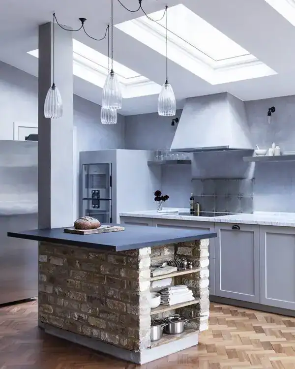Modern kitchen with pendant lighting and skylights.