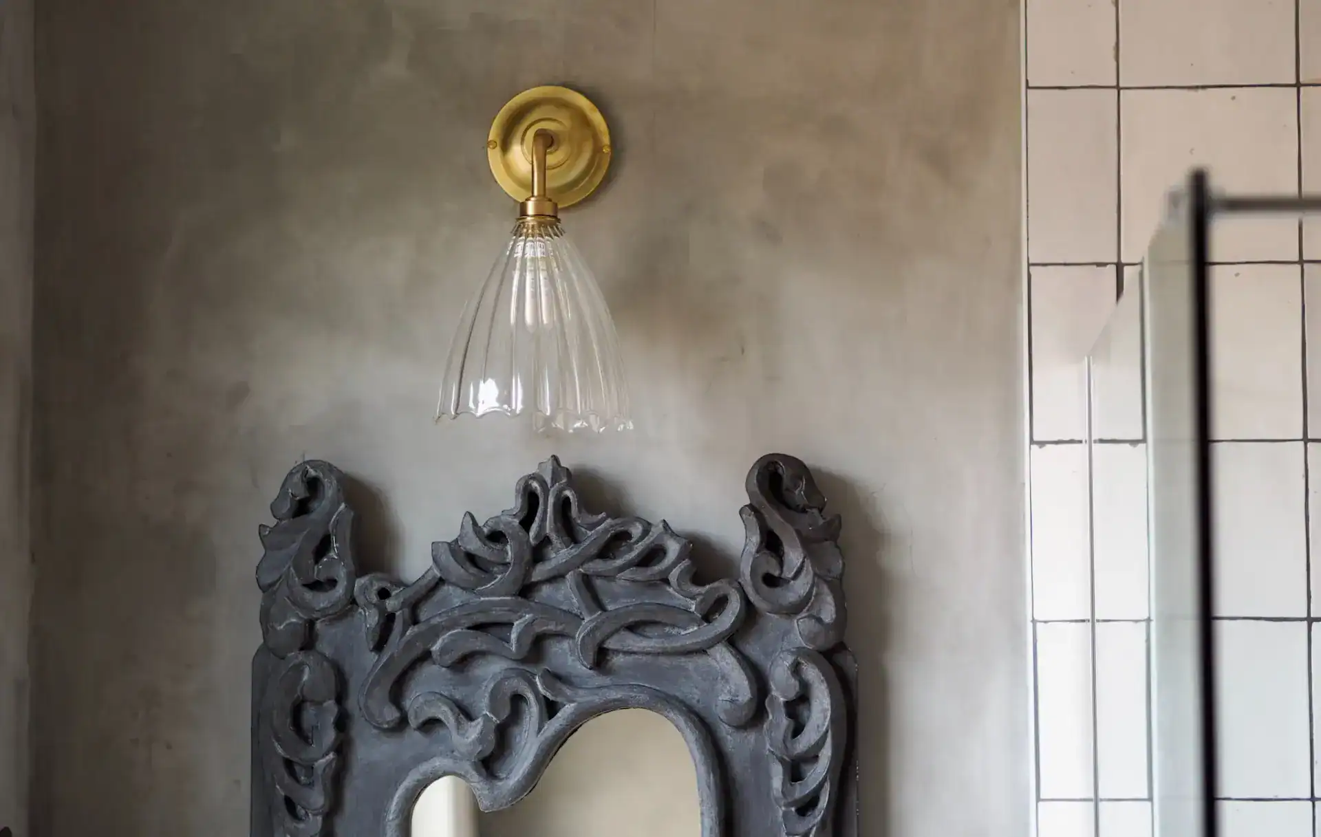 Elegant wall-mounted glass sconce with brass fixture.