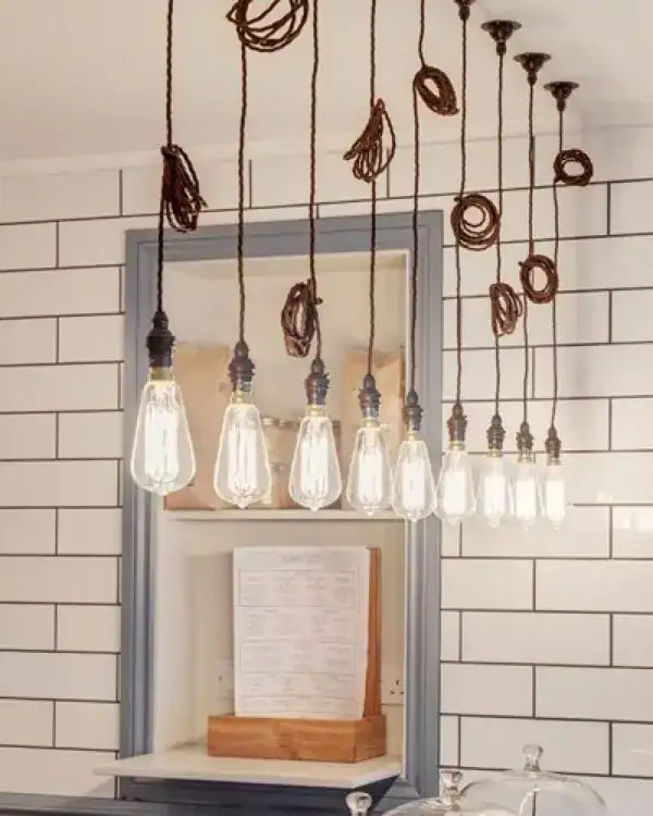 Edison bulb pendant lights with decorative hanging cords in a modern interior.