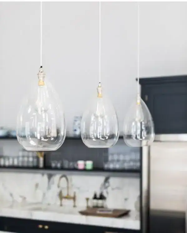 Modern glass pendant lights for kitchens.
