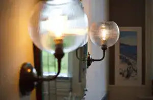 Elegant wall-mounted glass and brass light fixtures.