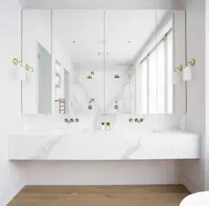 Modern white bathroom with stylish lighting fixtures.