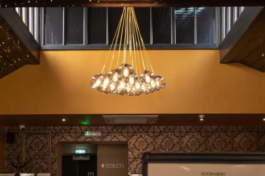 Elegant modern chandelier with multiple bulbs and gold accents.