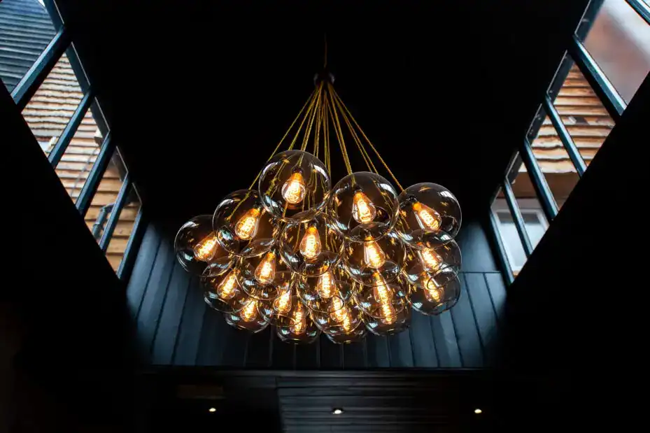 Elegant modern chandelier with multiple exposed bulbs.