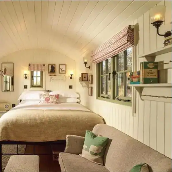 Soft ambient lighting in a cosy bedroom with white wooden walls and vintage decor.