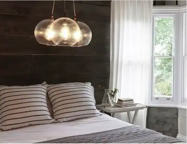 LED pendant lighting above a bed in a modern bedroom.