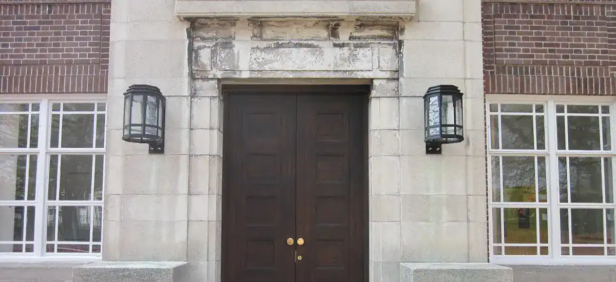 Elegant exterior wall lights on a historic building.
