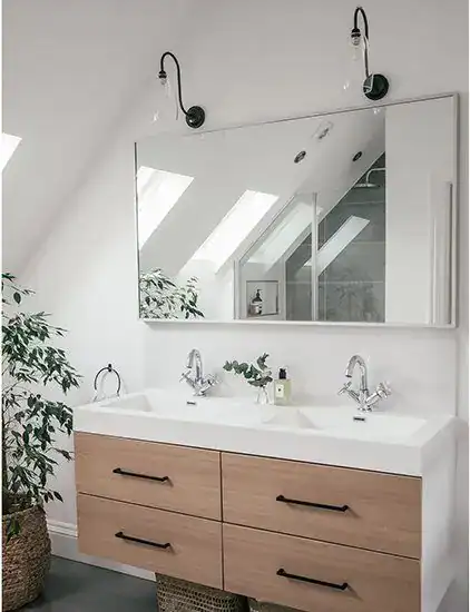 Double bathroom vanity with wall-mounted lighting and large mirror, bright and contemporary design.
