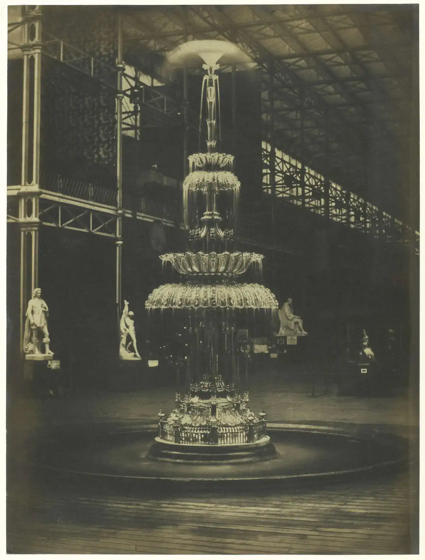 Vintage ornate fountain with lighting display in a historic indoor setting.