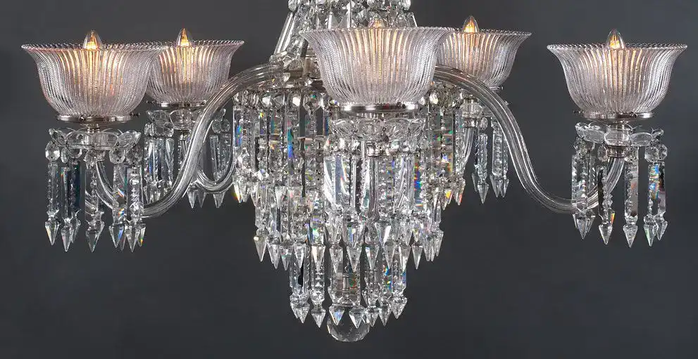 Luxurious crystal chandelier with multiple glass shades and hanging prisms, ideal for sophisticated.