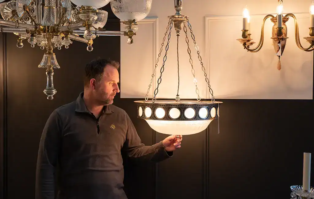 Elegant chandelier with modern design in a showroom setting.
