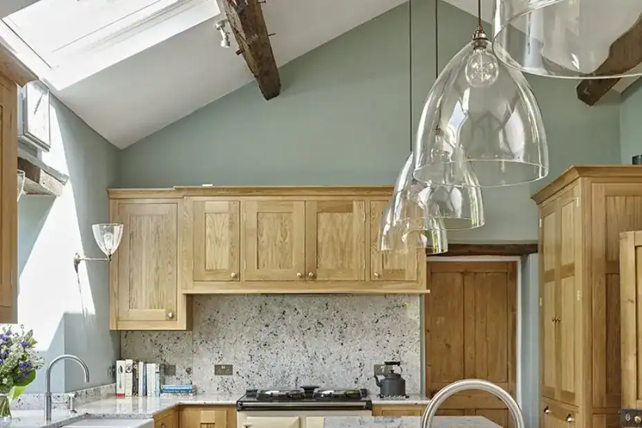 Modern kitchen with wooden cabinets and stylish pendant lighting fixtures.