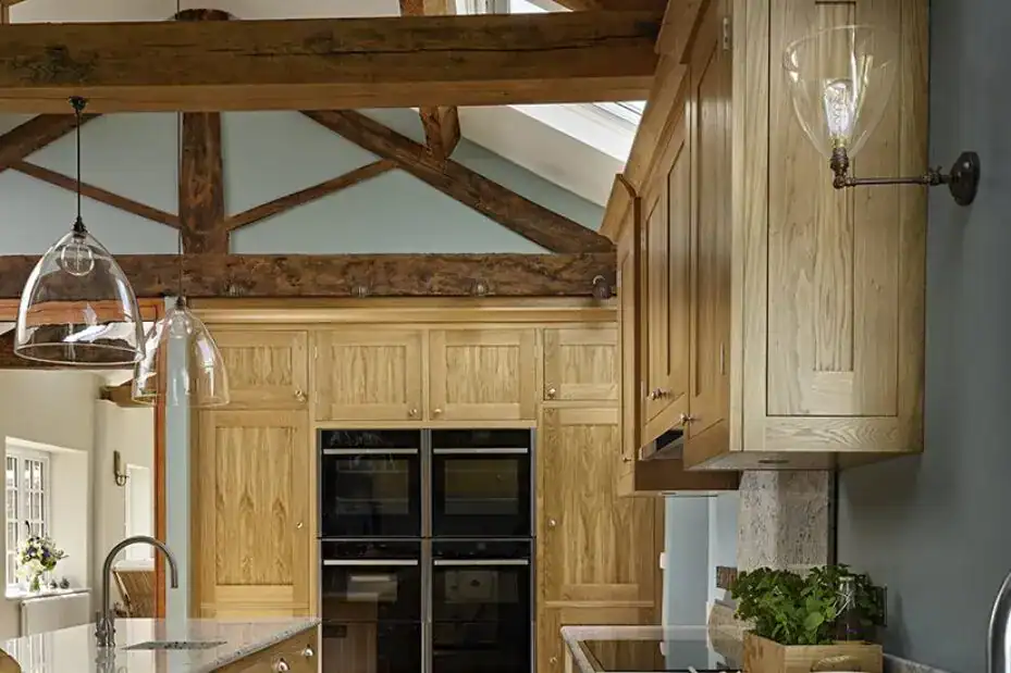 Bright kitchen with wooden cabinets and modern lighting fixtures.