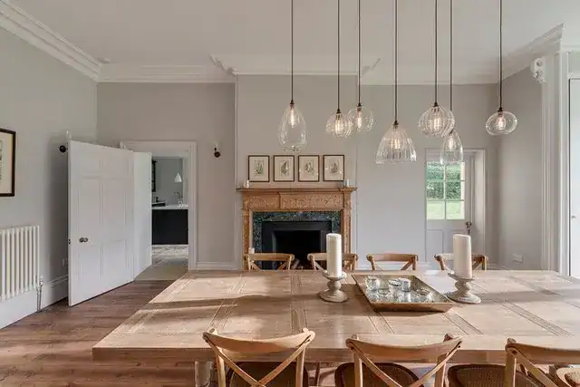 Elegant dining room with modern pendant lights and classic decor.