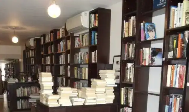 Bookshelves filled with a variety of books in a modern interior setting.