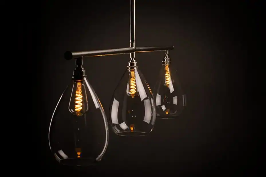 Pendant lighting with teardrop-shaped glass shades and vintage filament bulbs.