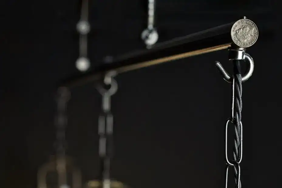 Close-up of a hanging chain with a coin for scale.