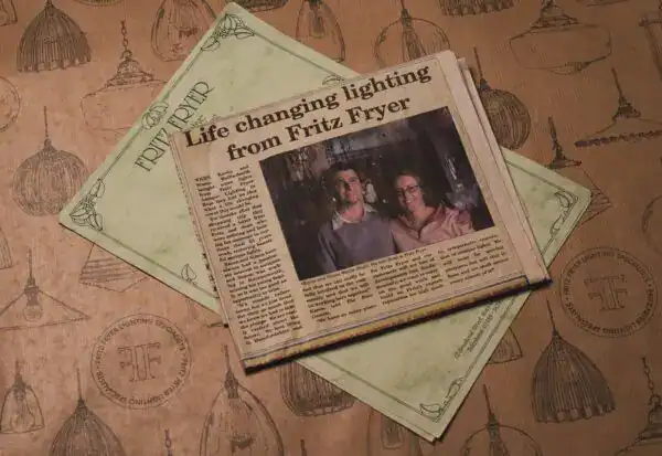A newspaper article titled "Life changing lighting from Fritz Fryer" with two men pictured.