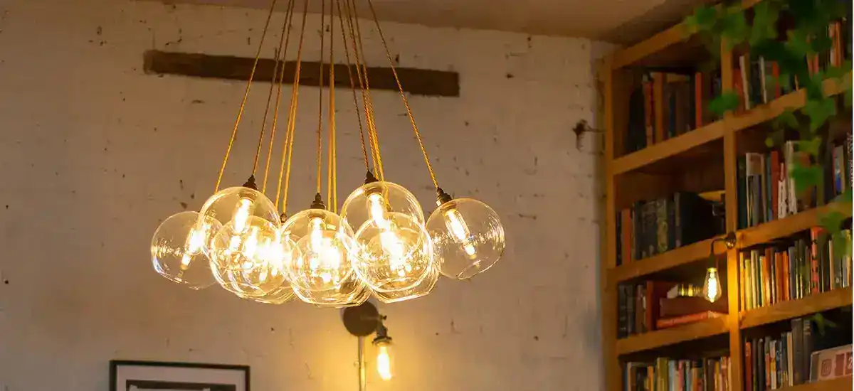 Modern glass pendant light fixture with multiple bulbs.