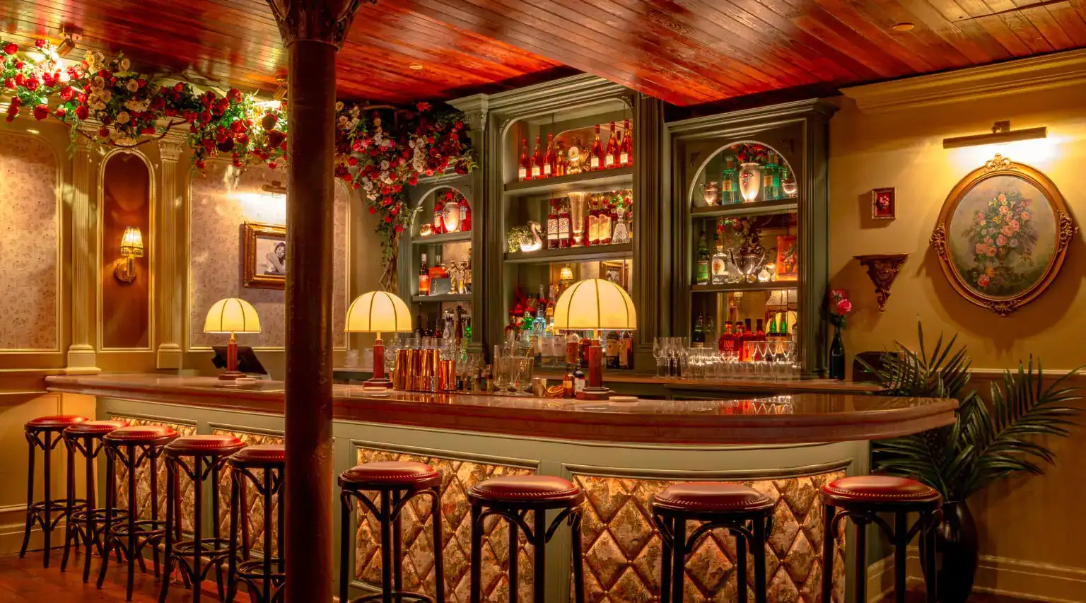 Elegant bar with warm lighting, vintage decor, and a well-stocked shelf in a cosy setting.