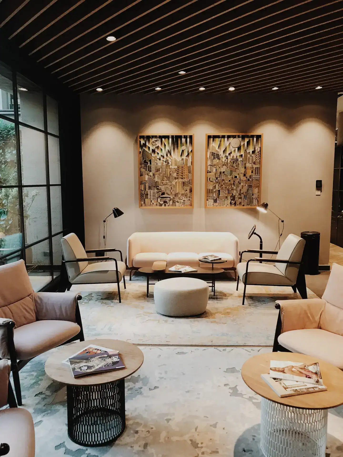 Modern lounge area with stylish seating and contemporary wall art in a well-lit interior.