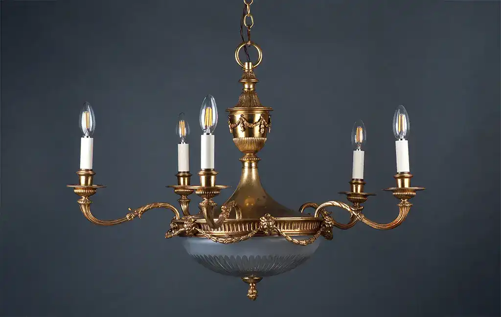 Elegant vintage brass chandelier with seven candle-style lights for classic interior lighting.