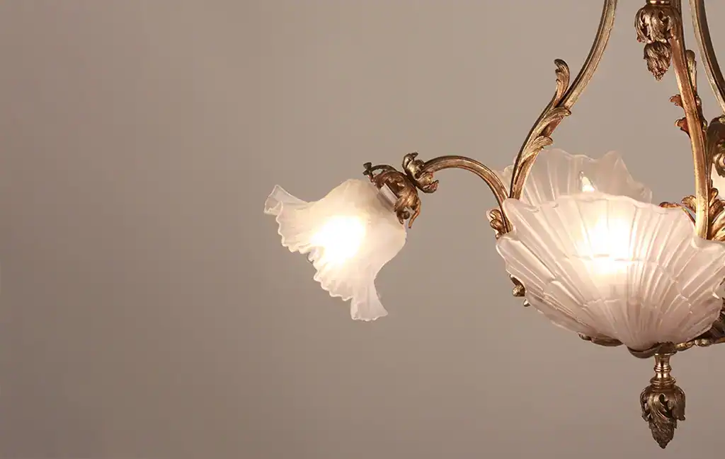 Elegant vintage chandelier with floral glass shades.