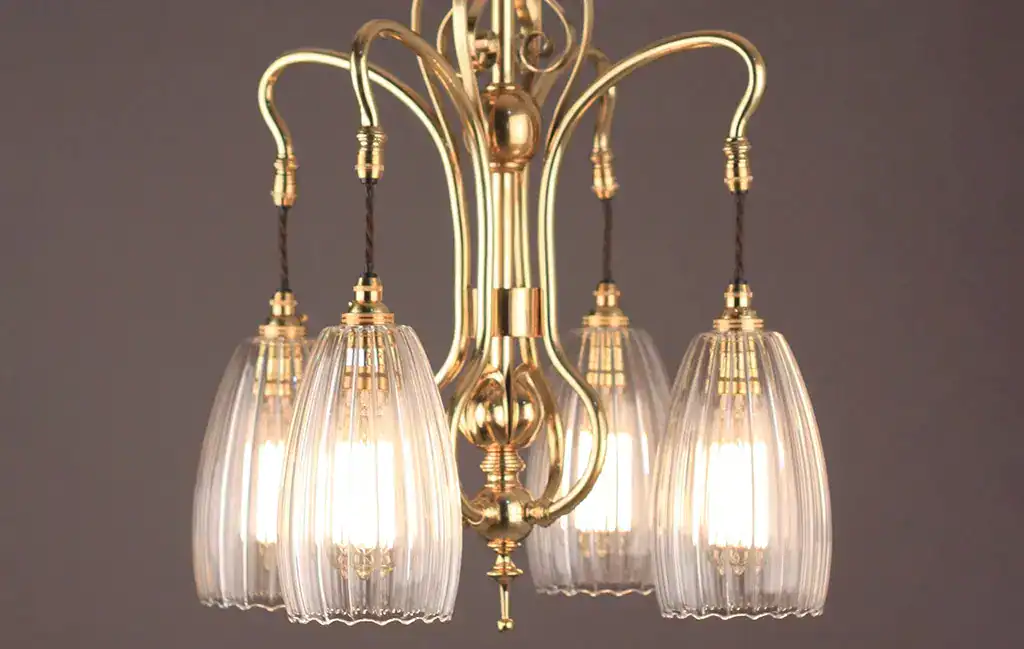 Elegant vintage brass chandelier with glass shades for classic interior lighting.