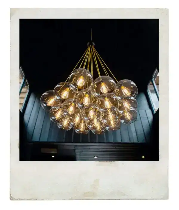 Elegant modern chandelier with multiple glass globes and warm lighting.