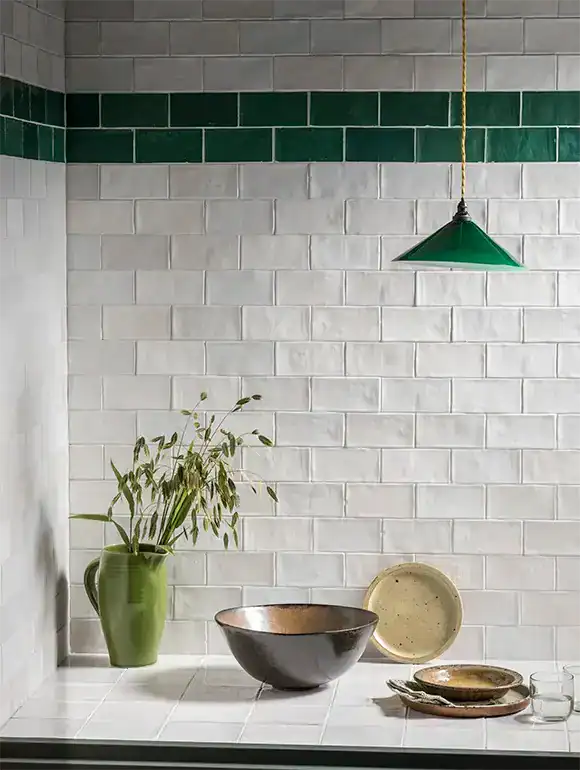 Modern green pendant light over kitchen counter.