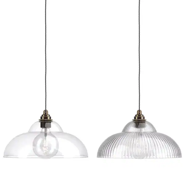 Pendant lights with clear glass shades and exposed bulbs, ideal for contemporary kitchen lighting.