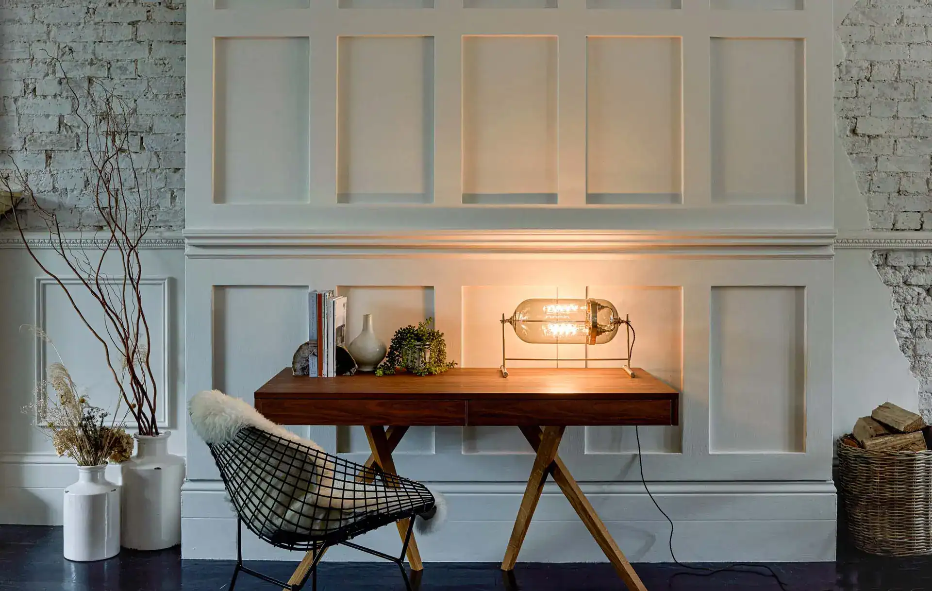 Wall-mounted vintage-style glass lamp with warm lighting in a modern interior setting.