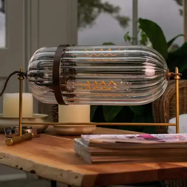 Modern glass table lamp with filament bulb, stylish design for contemporary interiors.