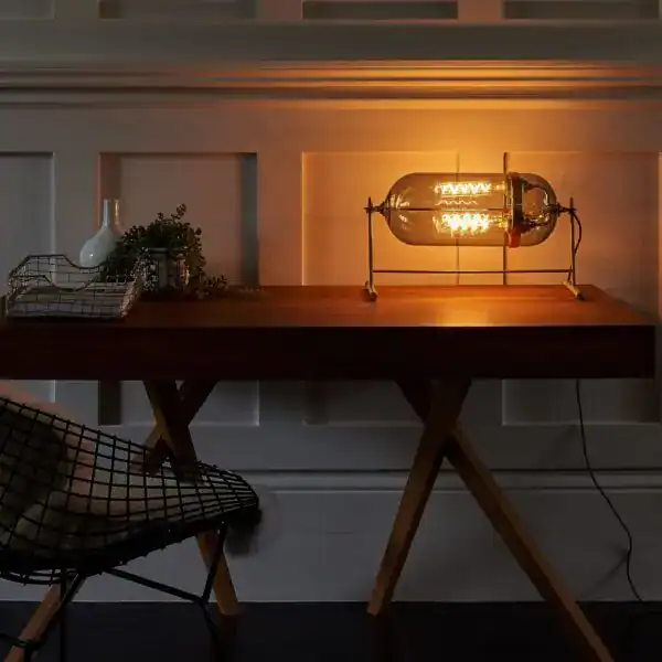 Vintage Edison-style table lamp on wooden desk.