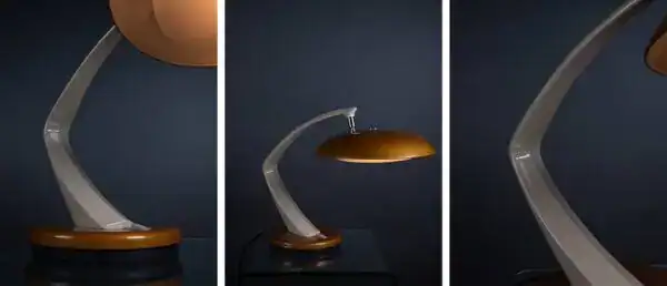 Elegant modern table lamp with curved metallic arm and wooden base.