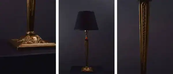 Classic gold table lamp with black lampshade and decorative base for sophisticated lighting.