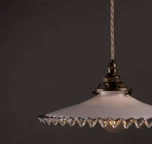 Vintage pendant light with decorative edge, hanging from twisted cord.
