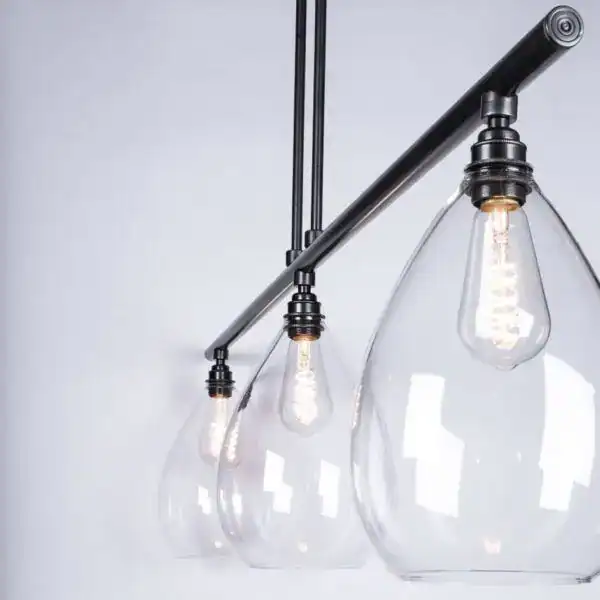 Pendant lighting with clear glass shades and vintage-style filament bulbs.